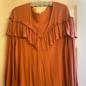 Leigh Blouse v-neck, ruffled front & back. 100% viscose, elastic wrist.